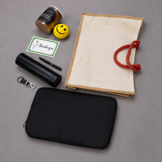Collection of items including a black pouch, notebook, pen, bottle, and small container on a gray surface.