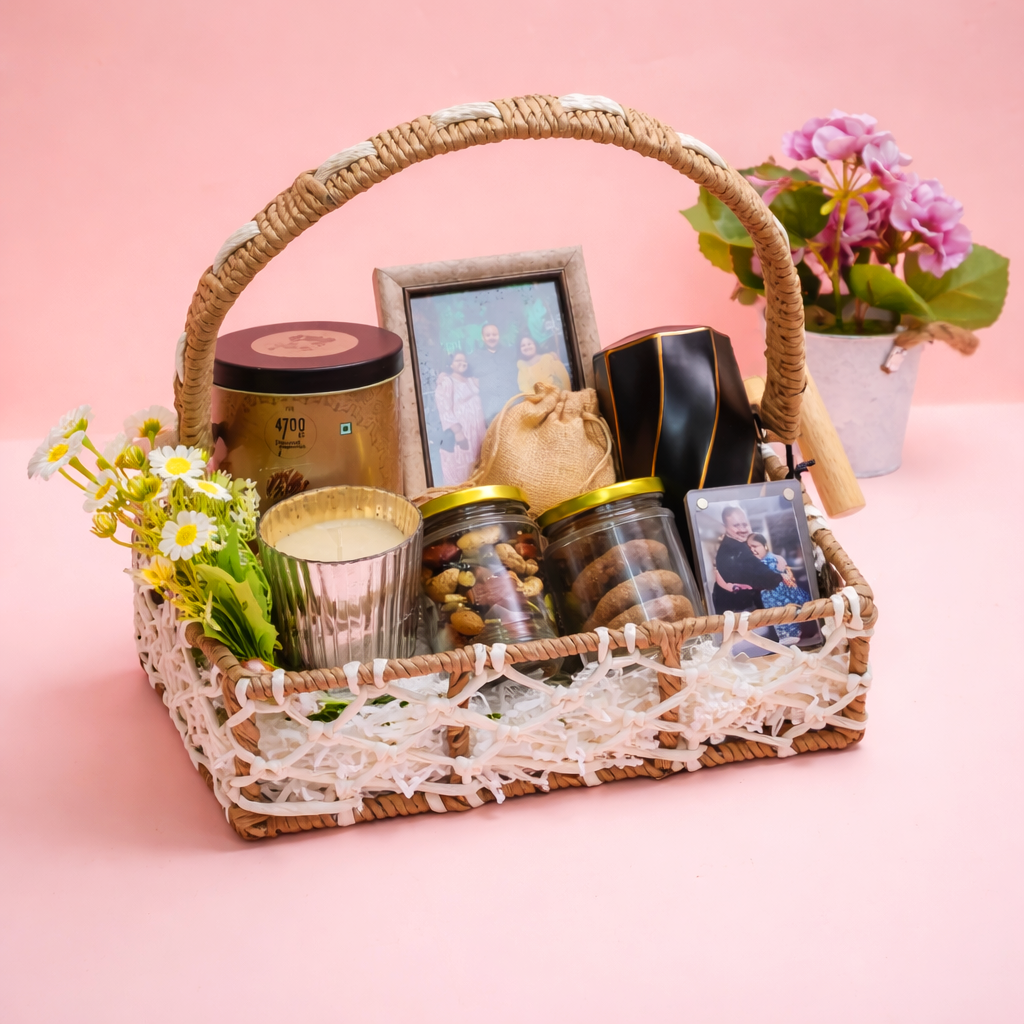 Gift basket with candles, jars, and a photo frame on a pink background