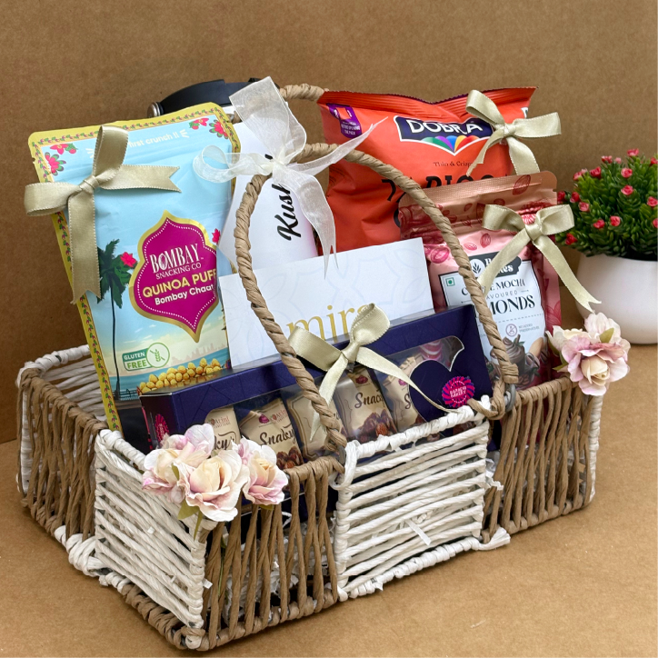 Gift basket with snacks and flowers on a brown background