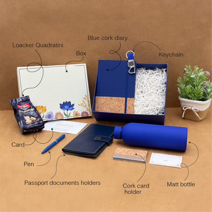 Collection of stationery items including a blue cork diary, keychain, pen, and other accessories on a brown background.