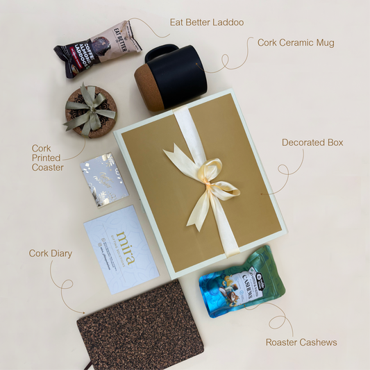 Collection of cork products including a mug, coaster, diary, and cashews on a light background.