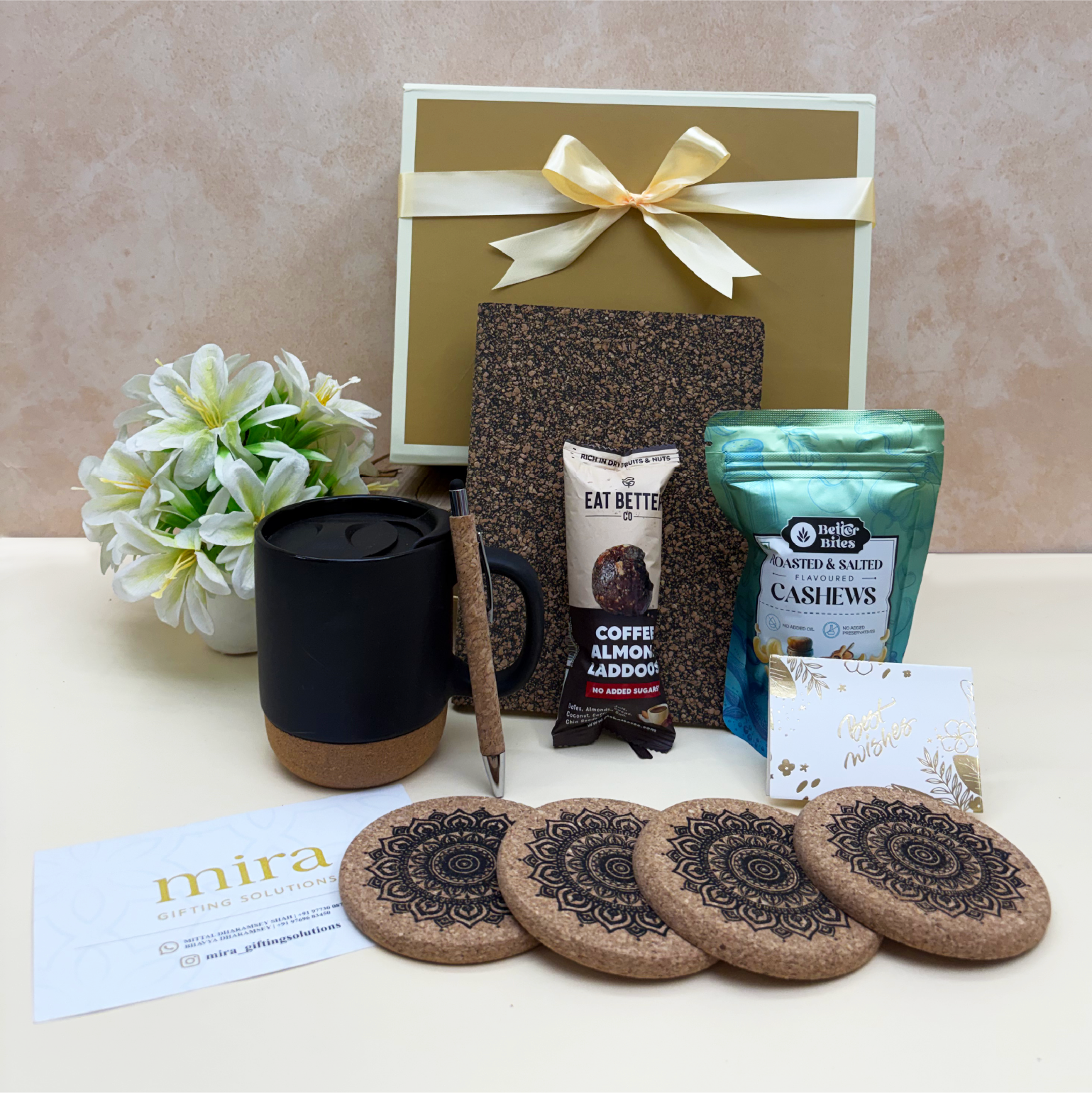 Gift set with coffee mug, snacks, and coasters on a beige surface
