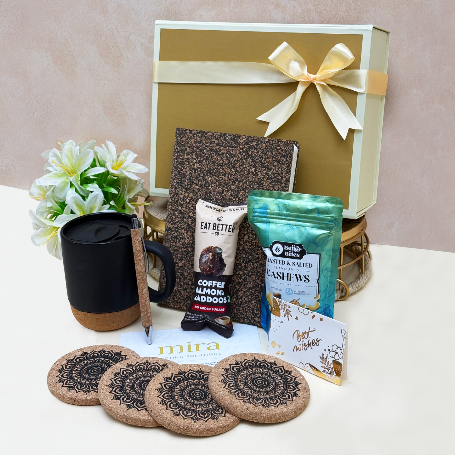 Gift set with a mug, notebook, and snacks on a table with a beige background