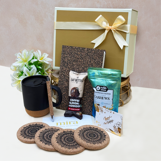 Gift set with a mug, notebook, and snacks on a table with a beige background