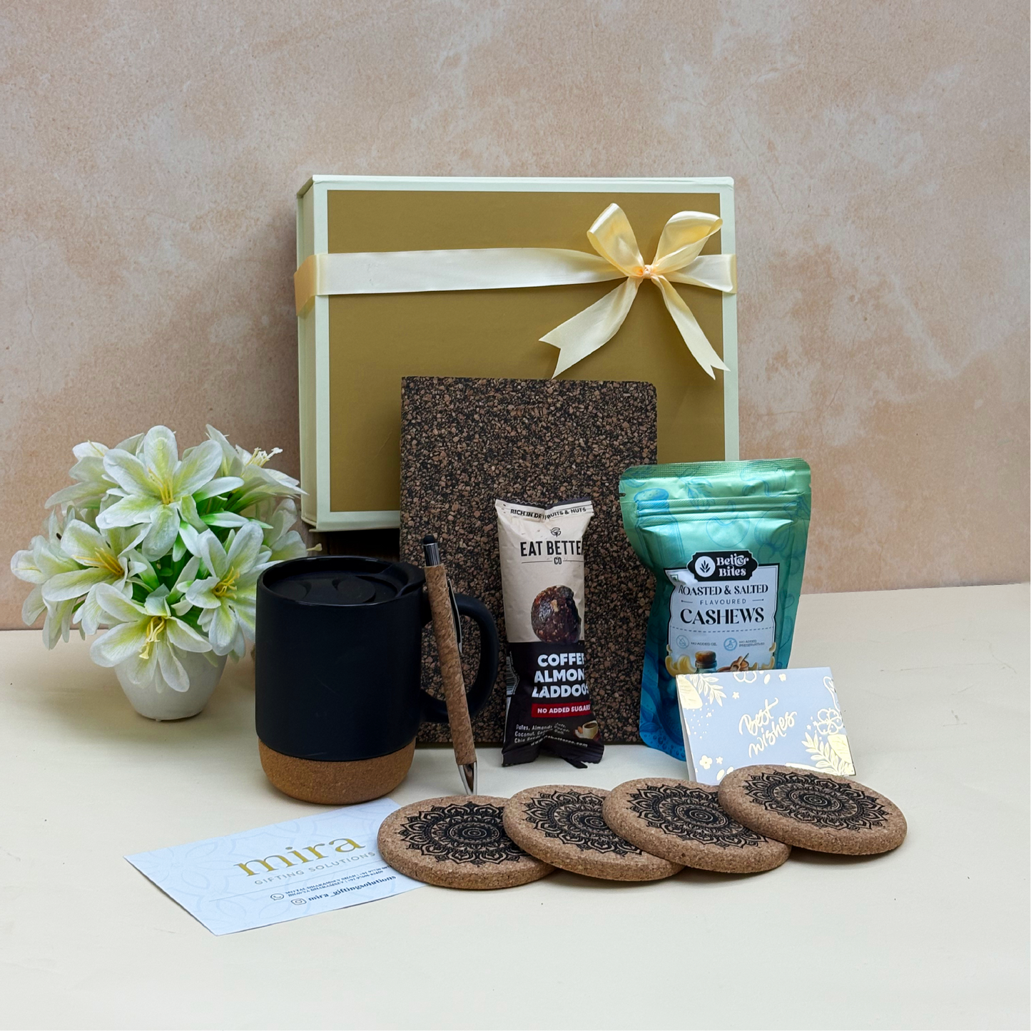 Gift set with a mug, cookies, and snacks on a beige surface
