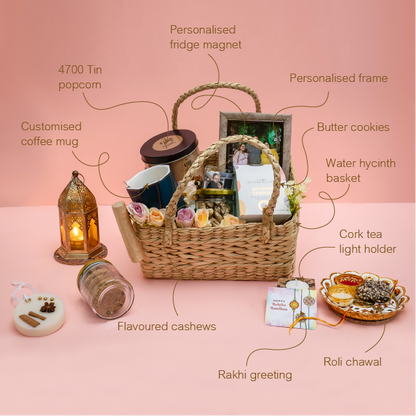 Gift basket with various items on a pink background