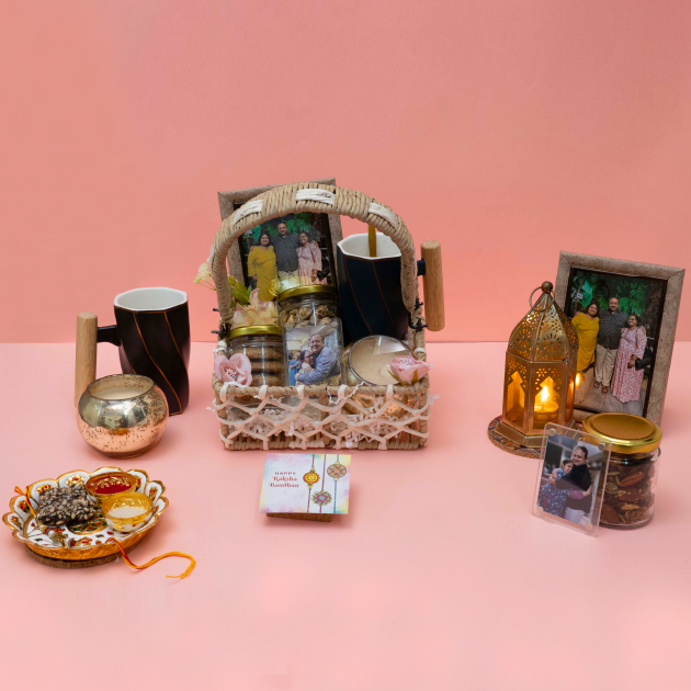 Gift basket with candles, jars, and photo frames on a pink background