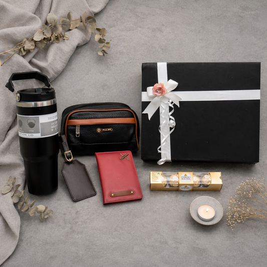Collection of travel-related items including a thermos, wallet, and gift box on a gray surface.