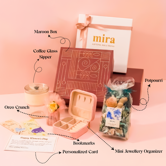 Gifting set with maroon box, coffee glass sipper, oreo crunch, potpourri, personalized card, bookmarks, and mini jewelry organizer on a pink background.