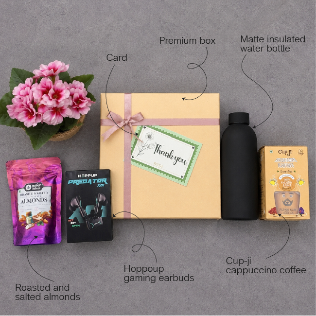 Gift set with a box, gaming earbuds, coffee, and other items on a gray background